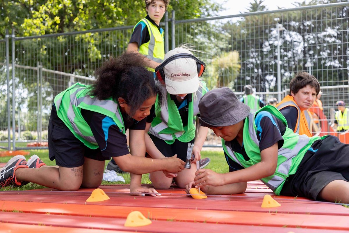 Tamariki at play with a tool on the playground