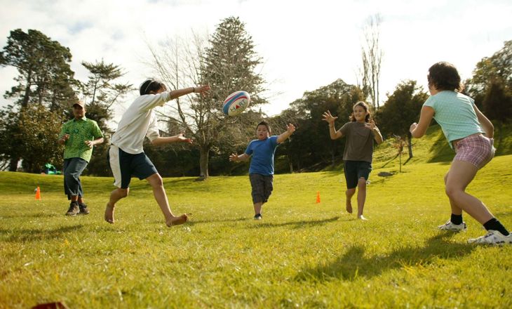 A family playing rugby on a field