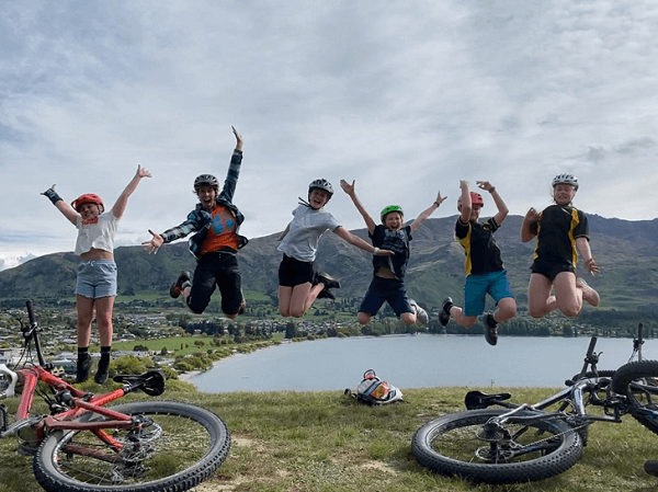 6 young women jumping for joy in the outdoors