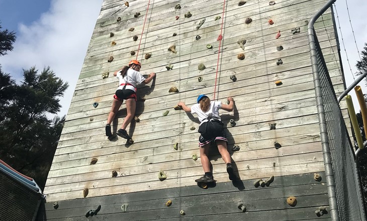 Two young women on a climbing wall