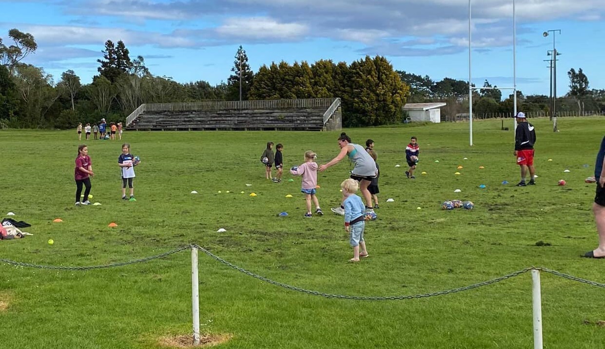 Kids playing outside with cones and balls