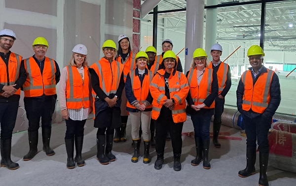 Group of people standing in a row in high vis gear