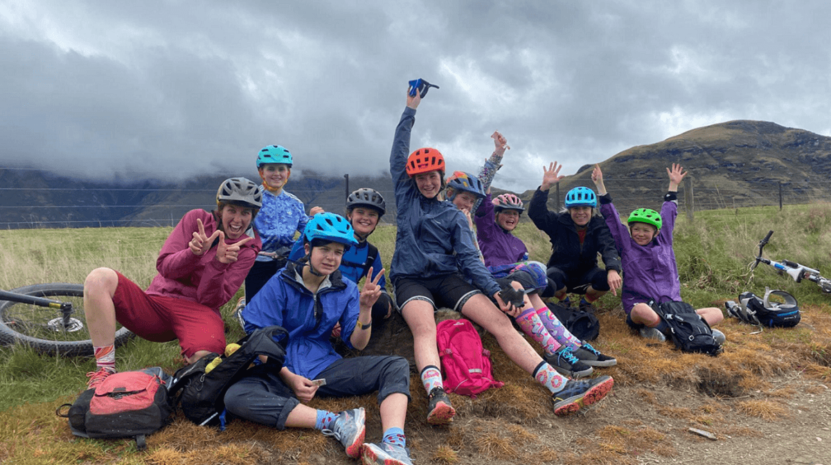 9 young women taking a break on their dirt bike ride