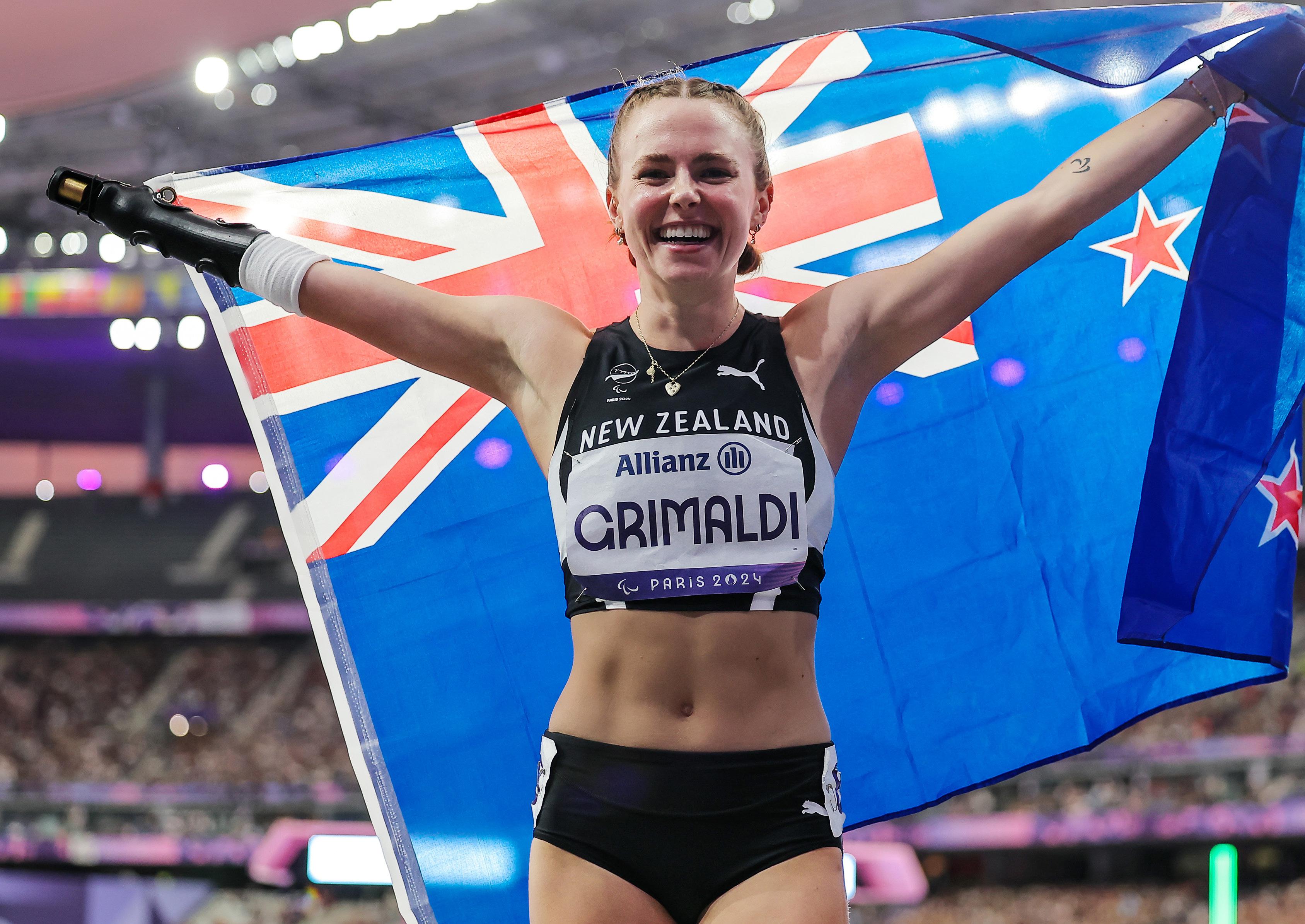 Anna Grimaldi holding a NZ flag