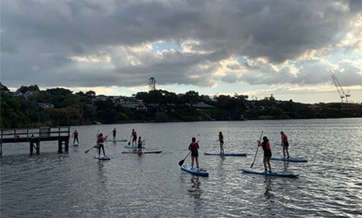 Group of people out paddleboarding