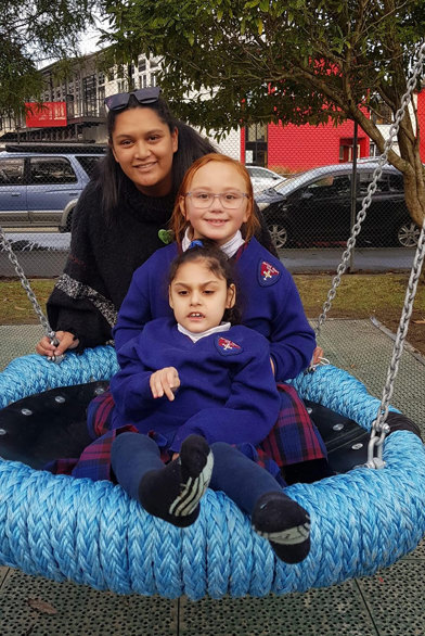 Family enjoying a big playground swing