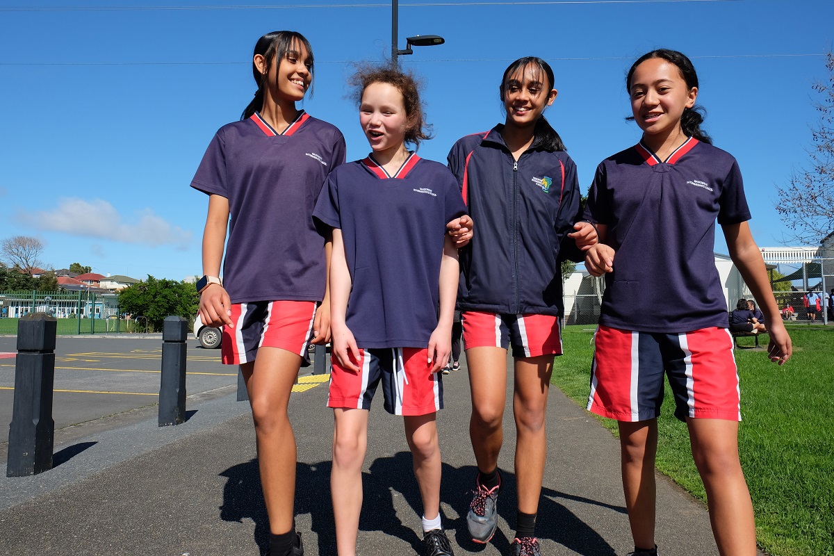 Group of young women walking outside for a PE class